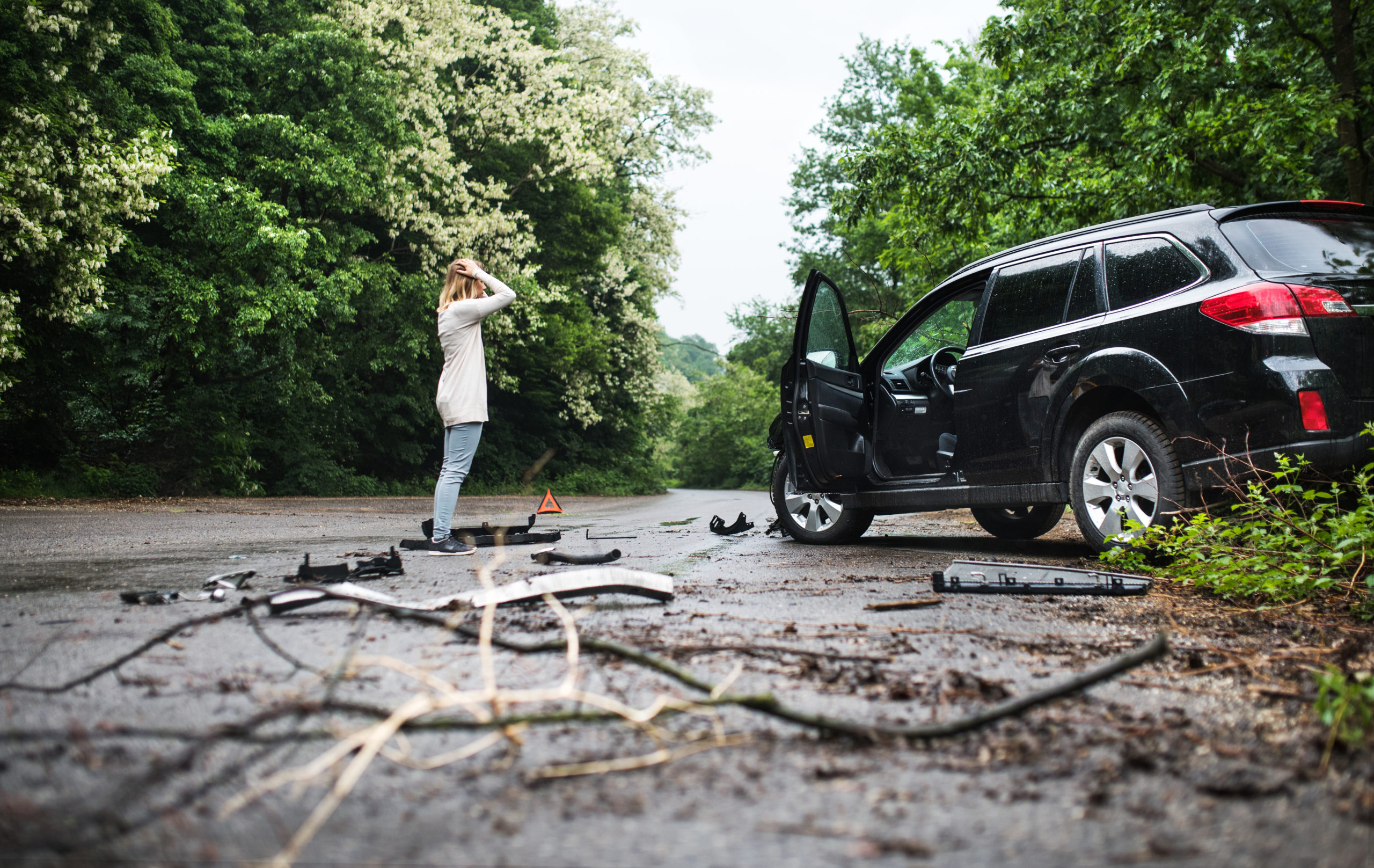 Woman at car accident on phone