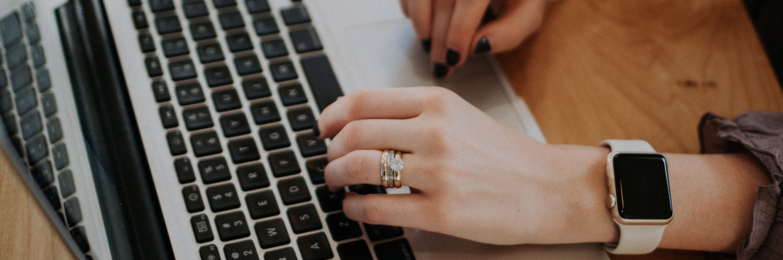 hands typing on a laptop