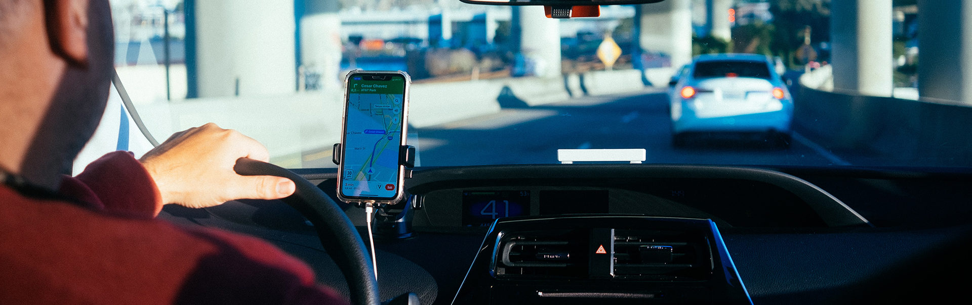 rideshare person driving with map on phone
